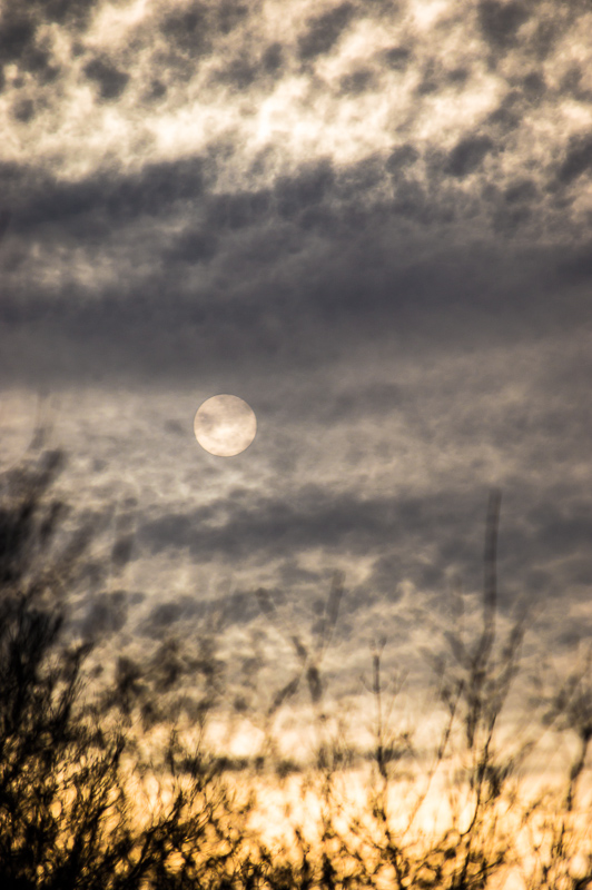 Sun obscured by clouds at sunset